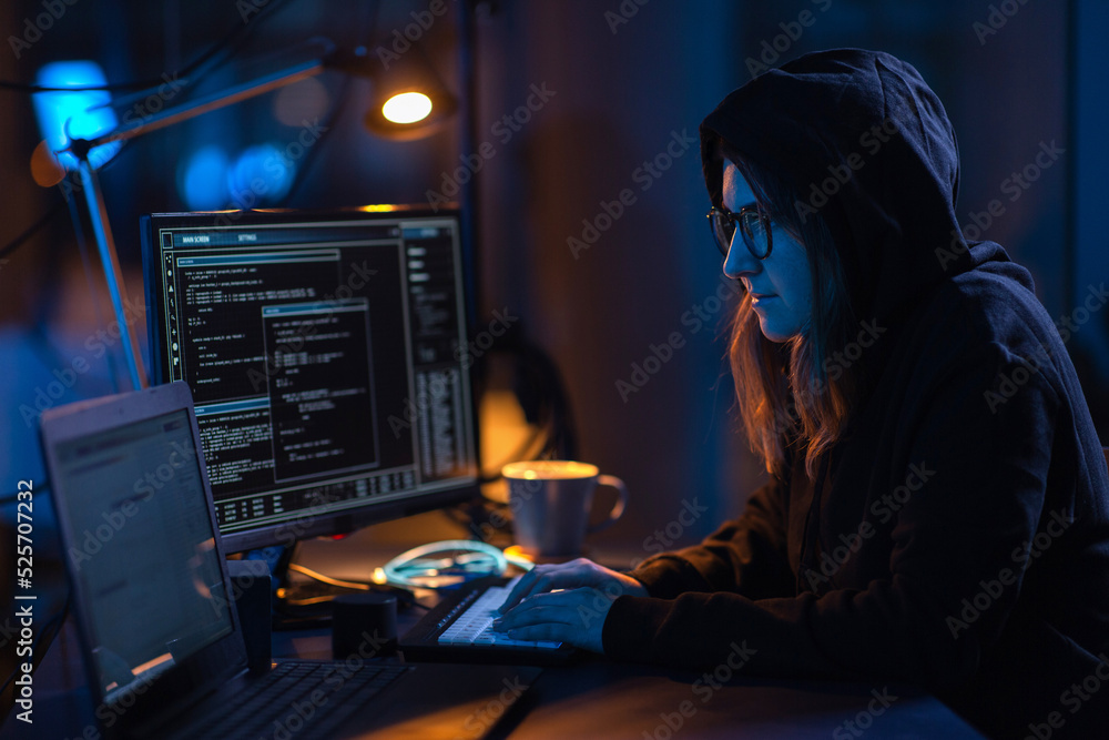 Poster cybercrime, hacking and technology concept - female hacker in dark room writing code or using comput