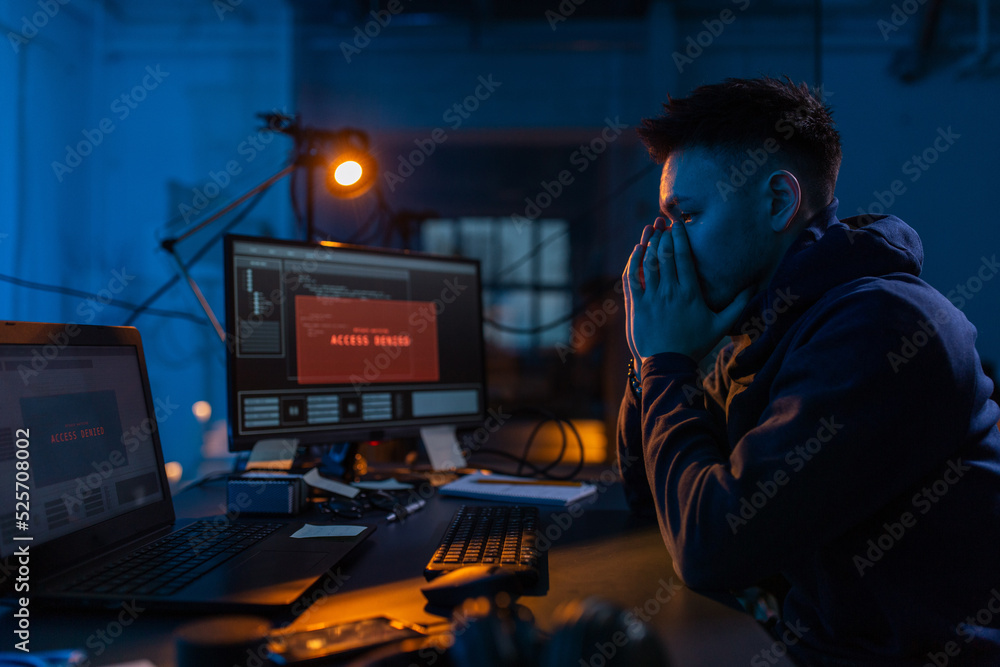 Poster cybercrime, hacking and technology concept - male hacker in dark room using computer virus program f