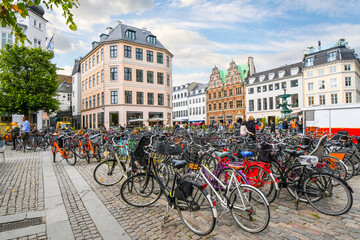 Naklejka premium Row after row of bicycles are parked in a group near the Stork Fountain in the Stroget shopping district, the longest pedestrian street in the world, in Copenhagen, Denmark.