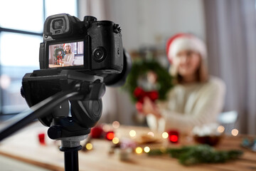winter holidays, diy and video blogging concept - close up of camera recording happy smiling woman...