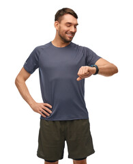 fitness, sport and healthy lifestyle concept - smiling man in sports clothes looking at his smart watch or tracker over white background