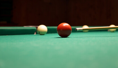 Hit the cue ball on the red ball. Resting with friends, playing snooker.