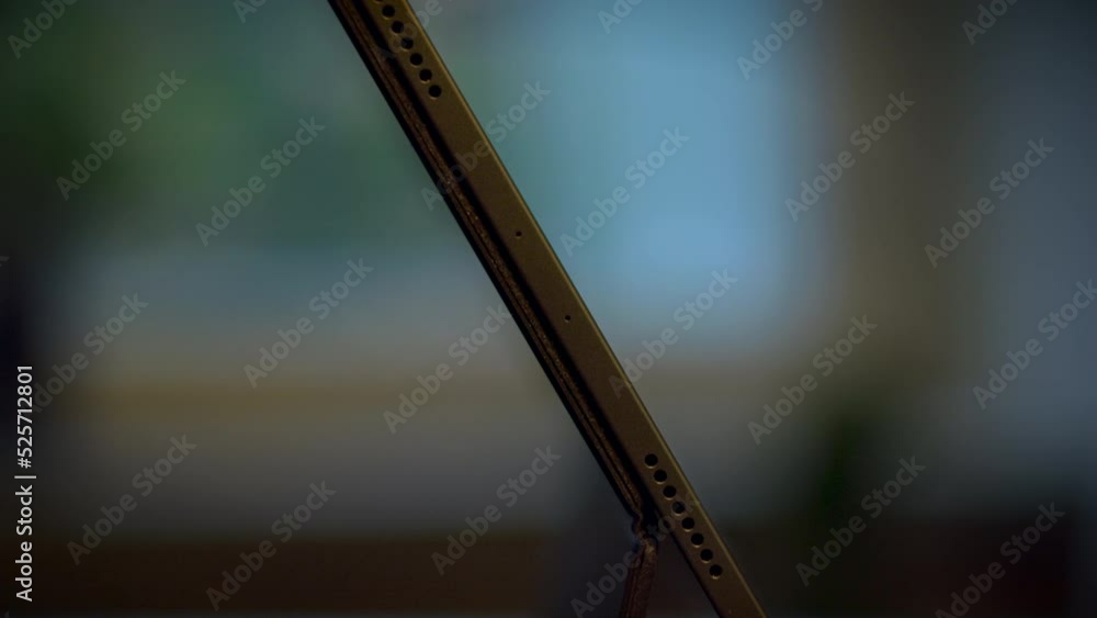Poster shallow focus shot of the side of a tablet with keyboard on black table with blur background