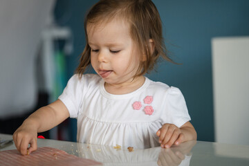 One girl small caucasian toddler child eat bread at home copy space