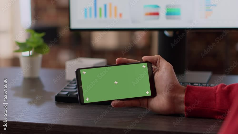 Poster businessman using horizontal green screen on smartphone, looking at isolated mockup copyspace with b