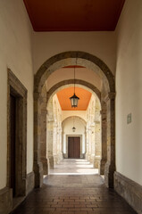 Fototapeta premium colonial architecture, arches surrounded by vegetation, play of light and shadows inside the space, natural materials