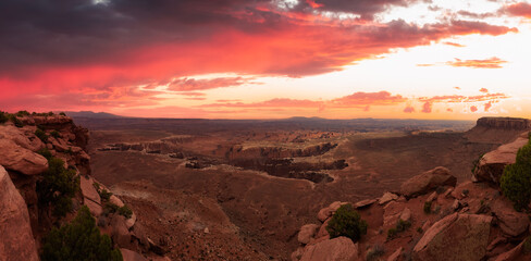 Fototapeta na wymiar Scenic Panoramic View of American Landscape and Red Rock Mountains in Desert Canyon. Colorful Sunset Sky Art Render. Canyonlands National Park. Utah, United States. Nature Background Panorama