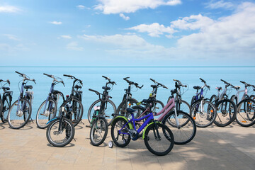Fototapeta premium Parking with bicycles on embankment near sea