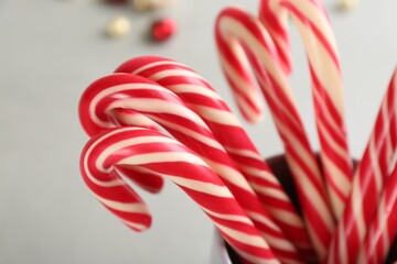 Sweet Christmas candy canes on light background, closeup