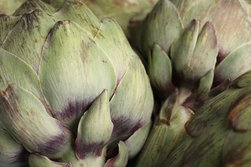 Fresh raw artichokes as background, closeup view