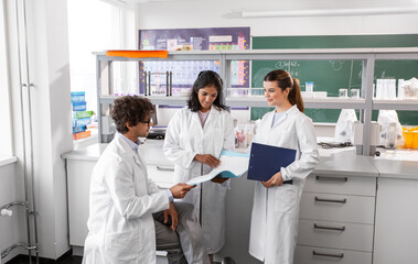 science research, work and people concept - international group of happy scientists with folder...