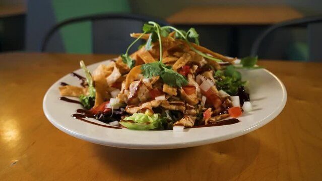 Colorful salad topped with tortilla strips and balsamic dressing, slider 4K