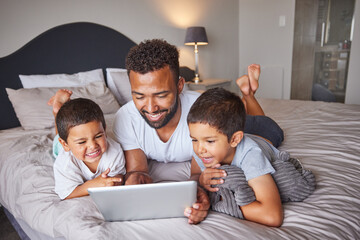 Technology, man and children relax on bed together to bond and have fun on the weekend with digital...