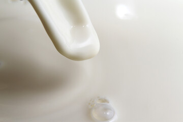 Fototapeta na wymiar Close up of pouring milk