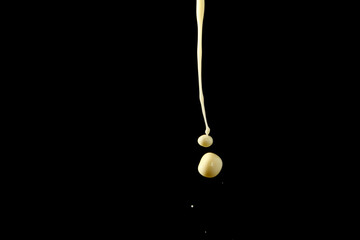 Fototapeta premium Milk droplet on black background