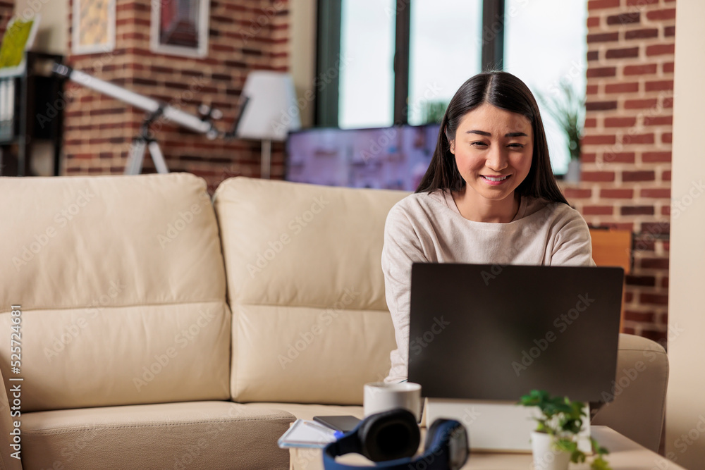 Poster successful authentic asian female freelancer watching tutorial video creative ideas at laptop comput