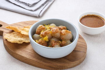 Cilok, traditional food from West Java, Indonesia, made from tapioca, chewy textured. Served with peanut sauce. 