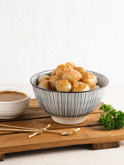 Cilok, traditional food from West Java, Indonesia, made from tapioca, chewy textured. Served with peanut sauce. 