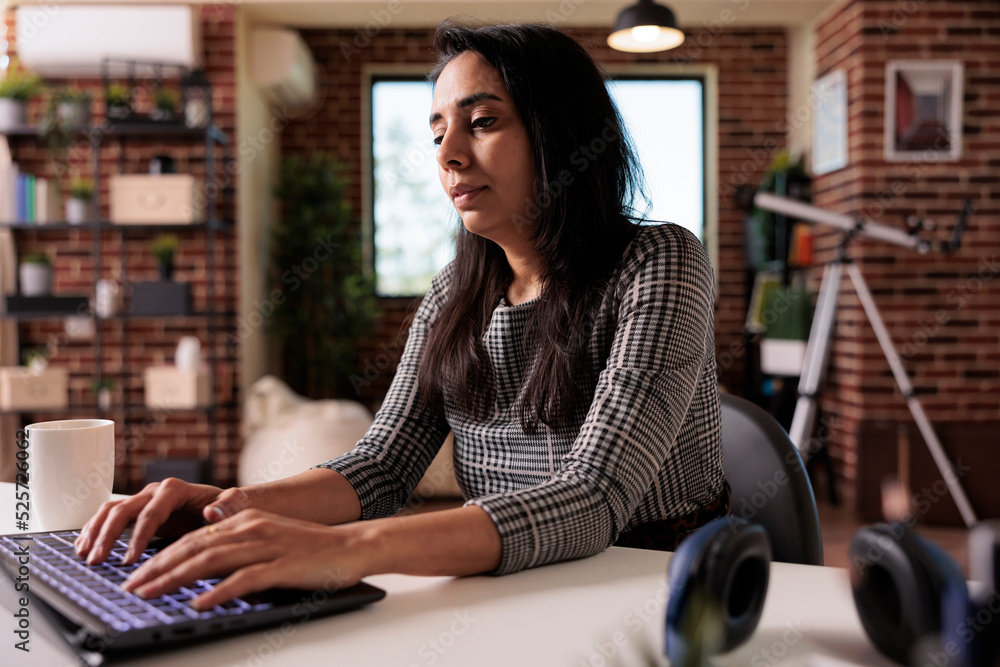 Poster indian woman working on laptop website, analyzing online report and browsing internet network from h