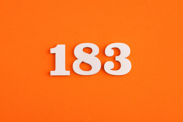 White wooden number 183 on eva rubber orange background