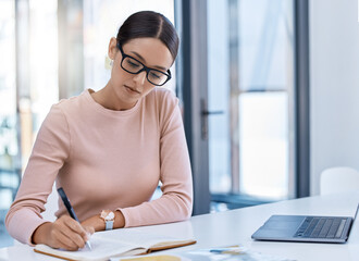 Planning, thinking and strategy with business woman writing notes while working on a laptop in a...
