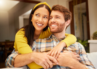 Happy and excited couple hugging thinking of future relaxing and sitting on a couch at home....