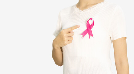 woman pointing pink ribbon on her chest, breast cancer awareness, healthcare concept