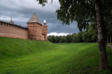 Fototapeta na wymiar View of the wall of the Novgorod Kremlin, Pokrovskaya Tower and Kokouy Tower on a summer day, Veliky Novgorod, Russia