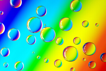 Macro shot of abstract bubbles on rainbow background.