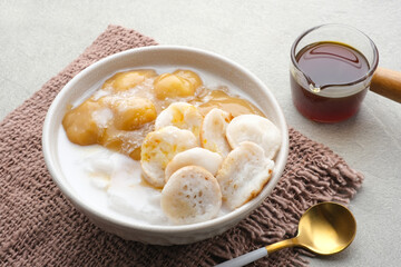 Serabi Bubur Sumsum with Candil Ubi. Indonesian traditional porridge. Served with palm sugar sauce. Sweet and savory. Popular food during ramadhan.
