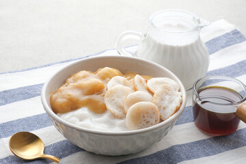 Serabi Bubur Sumsum with Candil Ubi. Indonesian traditional porridge. Served with palm sugar sauce. Sweet and savory. Popular food during ramadhan.
