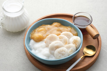 Serabi Bubur Sumsum with Candil Ubi. Indonesian traditional porridge. Served with palm sugar sauce. Sweet and savory. Popular food during ramadhan.
