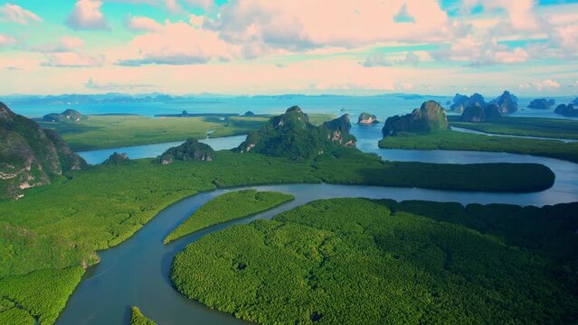 Drone flying over tropical forest, beautiful mangroves and winding river in sunset time. (Samed Nang Chee), Phang Nga, Thailand. green nature background. tropical seas in southeast asia. 4k drone
