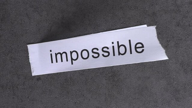 Replace the word impossible with the word possible. Business concept with letters and wobbly paper.
