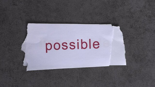 Replace the word impossible with the word possible. Business concept with letters and wobbly paper.
