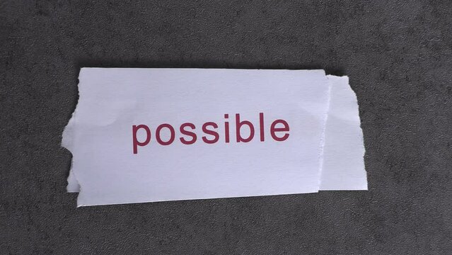 Replace the word impossible with the word possible. Business concept with letters and wobbly paper.
