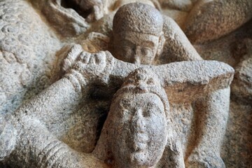 Battlefield scene of Hindu Goddess Durga fight with the Buffalo headed Demon with her army of female warriors is carved as Bas relief sculpture in the rock cut cave temples in Mahabalipuram, Tamilnadu