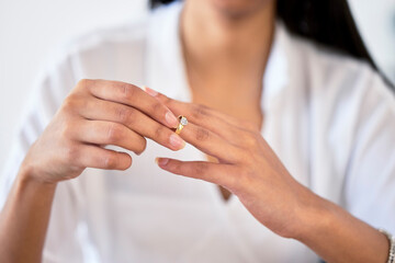 .Woman hand taking off ring or jewelry for divorce and break engagement after fail marriage....