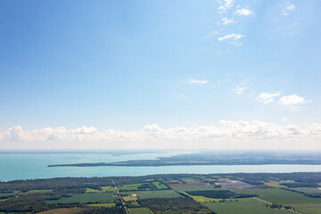 Innisfil water front beach shore line with farm land and lake simco in view 