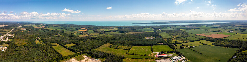 Innisfil water front beach shore line with farm land and lake simco in view 