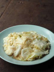 stir fried cabbage with fish sauce on wooden table