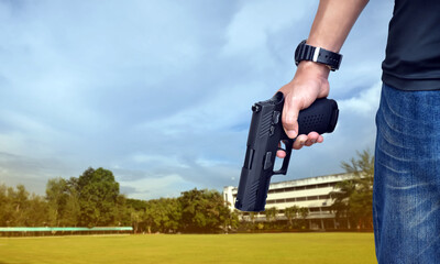 9mm automatic pistol holding in right hand of shooter, concept for security, robbery, gangster,...