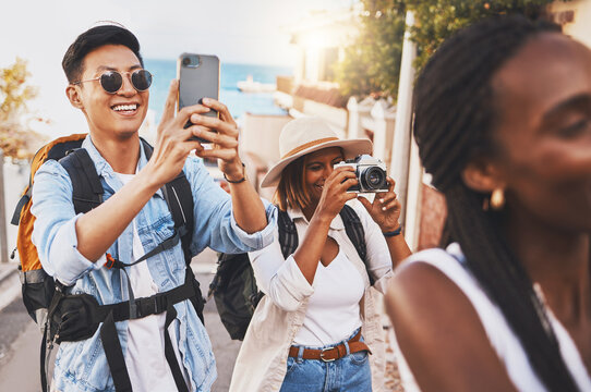 Happy photographer people on travel summer vacation or holiday for international tourism and lens flare. Young influencer or tourist man, woman and friends doing photography for social media branding