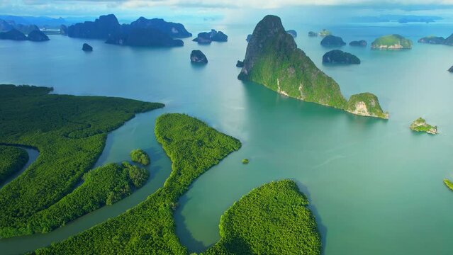 Aerial view from a drone flying over Phang Nga Bay, beautiful mangrove forest with river bend and many islands in the background. Samed Nang Chee, Phang Nga, Thailand. iconic of tropical scenery. 4K

