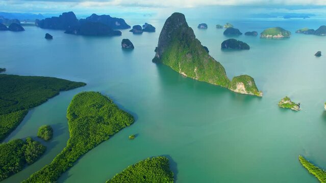 Aerial view from a drone flying over Phang Nga Bay, beautiful mangrove forest with river bend and many islands in the background. Samed Nang Chee, Phang Nga, Thailand. iconic of tropical scenery. 4K
