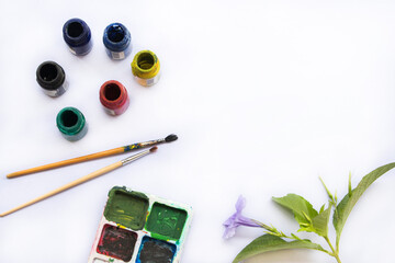 poster colour art, paintbrush and flowers of lifestyle arrangement flat lay postcard style on...