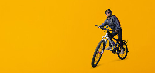 Fototapeta na wymiar Cyclist woman riding a bike isolated on yellow background, Clipping paths for design work empty free space