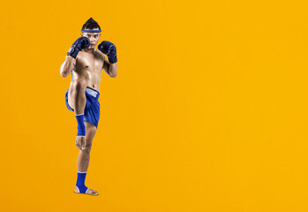 Muay thai, Asian man exercising thai boxing isolated on yellow background, Clipping paths for...