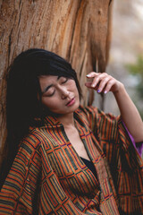 Portrait of sexy and young japanese woman with beautiful old traditional brown and orange kimono...