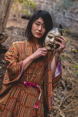 Portrait of sexy and young japanese woman with beautiful old traditional brown and orange kimono...